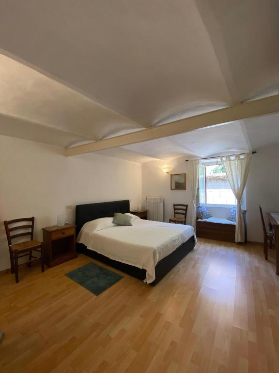 a bedroom with a bed and a table and a window at Da Nonna Puni in Orvieto