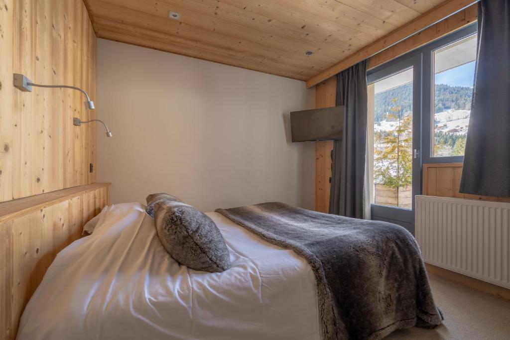 Postel nebo postele na pokoji v ubytování Chalet Les Rhodos