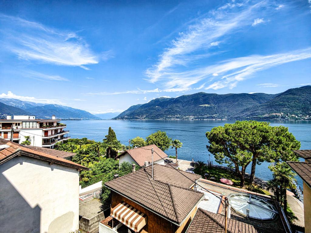 a view of a large body of water with mountains at Brissaghino al Lago 5* in Brissago