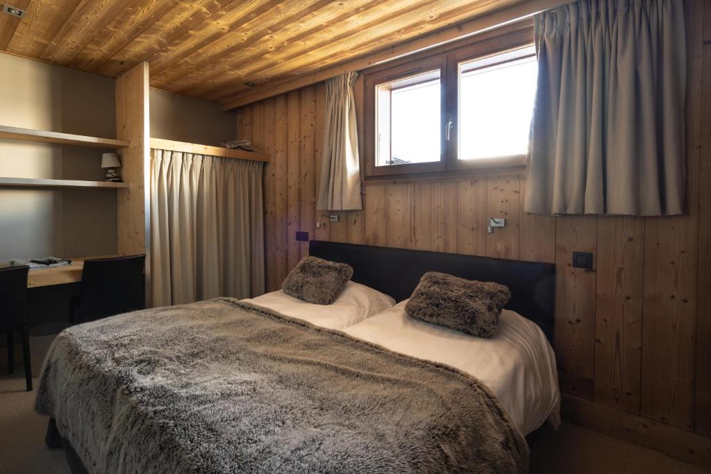 Postel nebo postele na pokoji v ubytování Chalet Les Rhodos