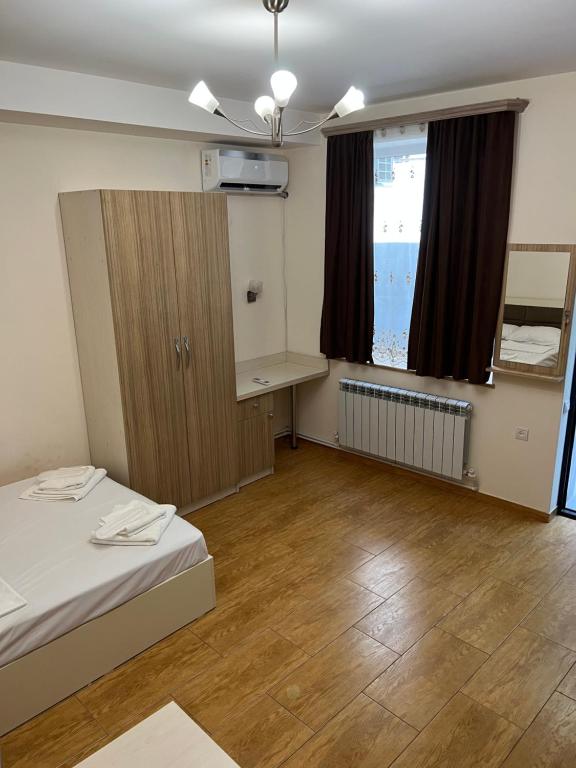 a room with a bed and a desk and a window at Cozy holiday home in Yerevan