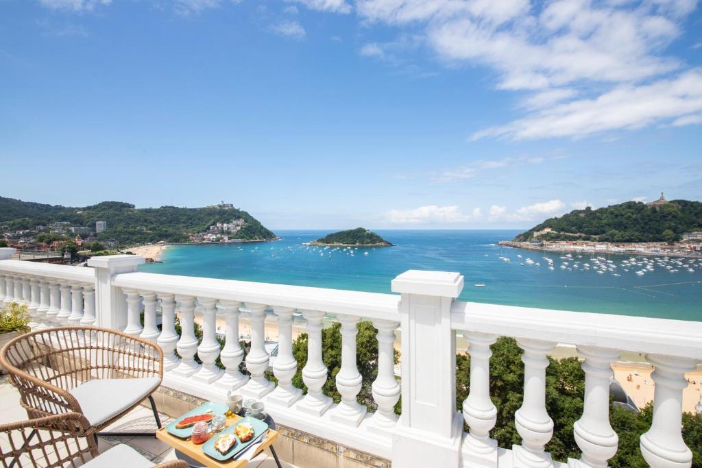 a view of the ocean from a balcony at Far Out Inn - Yoga guesthouse in San Sebastián