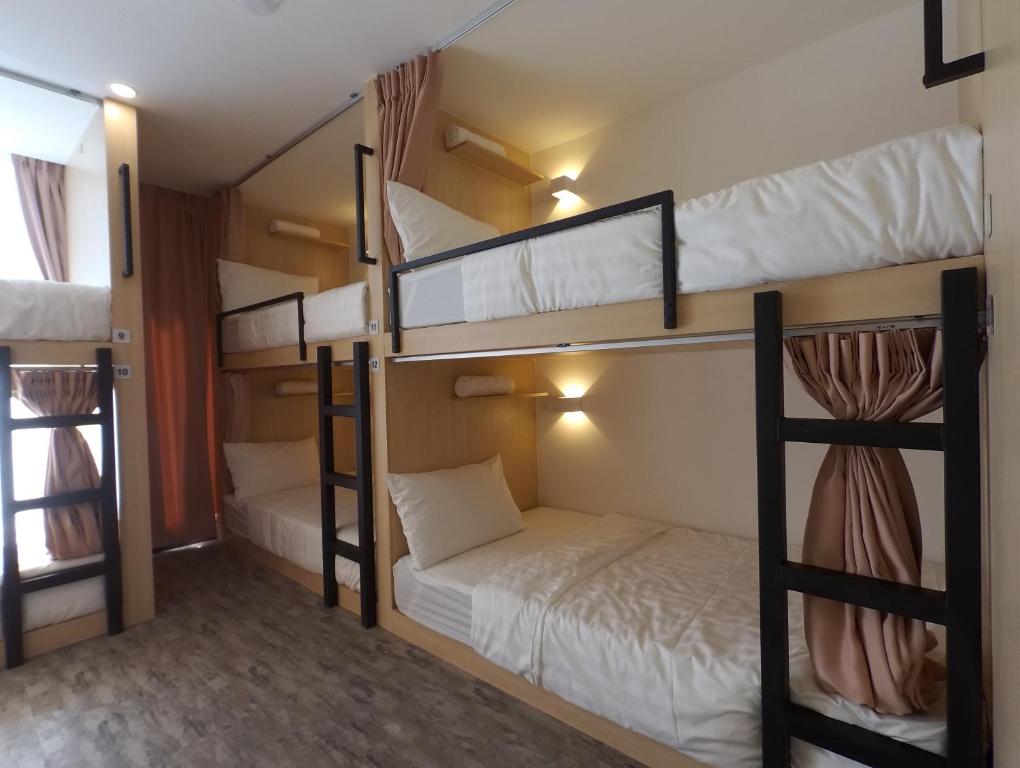 a room with three bunk beds in it at Signel Hostel in Kota Kinabalu