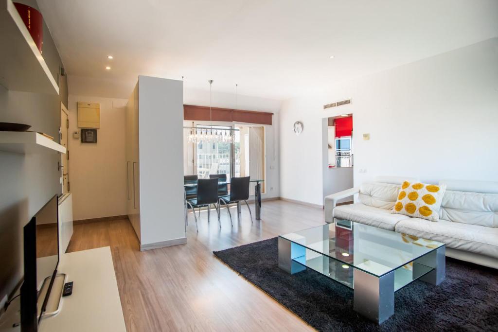 a living room with a white couch and a glass table at S2SEP498 - Great apartment with private terrace in Barcelona