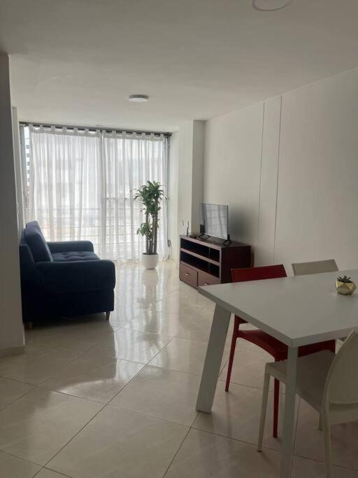 a living room with a table and a couch at Apartamento bien ubicado. in Bucaramanga