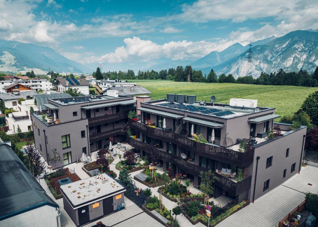 an aerial view of a building in a city with mountains at Alp Living Apartments Self-Check In in Innsbruck