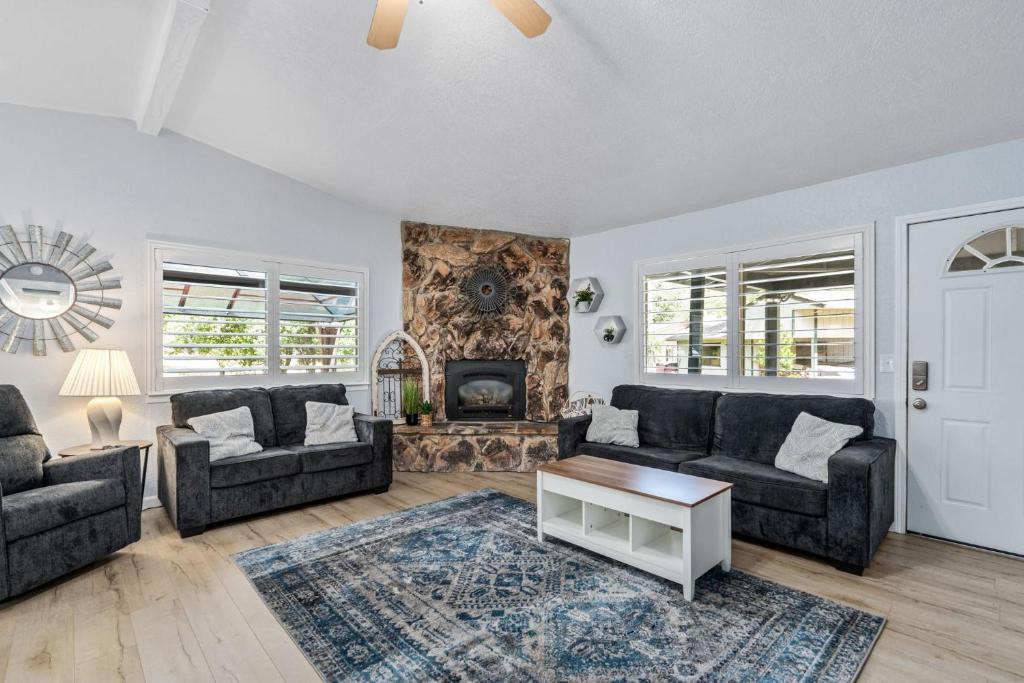 a living room with two couches and a fireplace at Sweet Haven - Home with EV Charger near Yosemite in Groveland