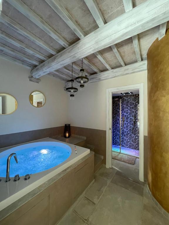 a large bathroom with a large tub and a window at L’ Aia del Principe in Montepulciano