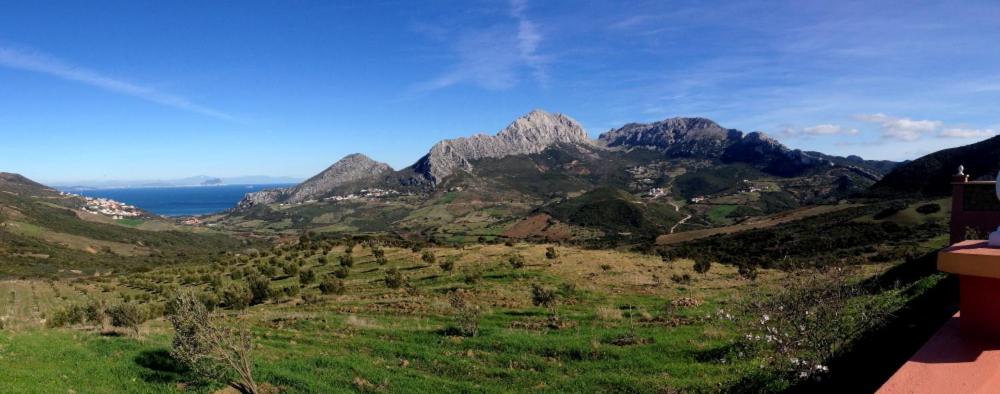 a view of a mountain range with the ocean at Coopérative Village Jbel Moussa du Tourisme in Rcham
