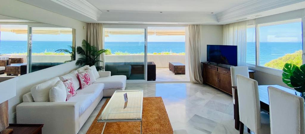 a living room with a couch and a tv at Marina Mariola by Coral Beach in Marbella