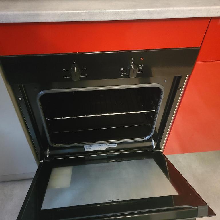 an oven with an open door in a kitchen at Appartement T2 Brest Pilier Rouge avec internet in Brest
