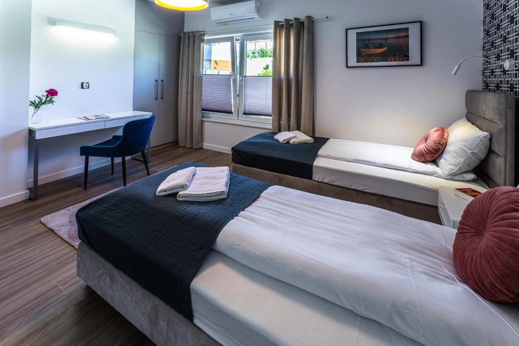 Postel nebo postele na pokoji v ubytování Klif Resort Apartamenty