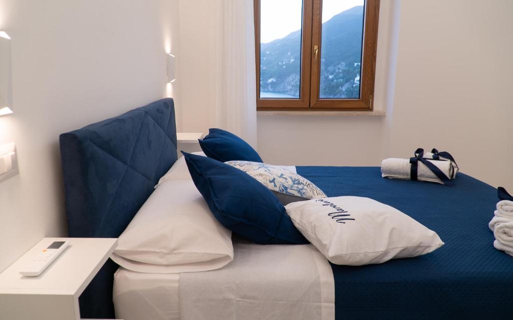 a blue and white couch with pillows on it at Mareterè in Vietri sul Mare