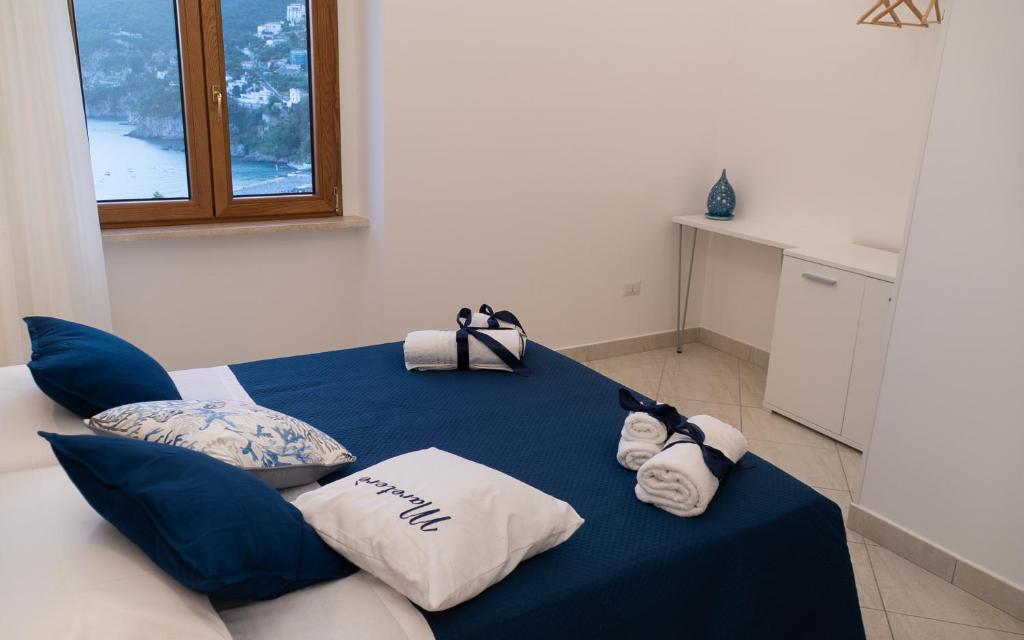 a room with a blue table with pillows on it at Mareterè in Vietri sul Mare