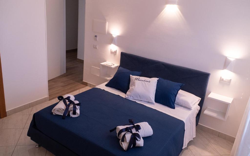 a bedroom with a blue bed with two bags on it at Mareterè in Vietri sul Mare