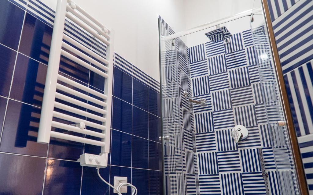 a bathroom with a shower with blue and white tiles at Mareterè in Vietri sul Mare