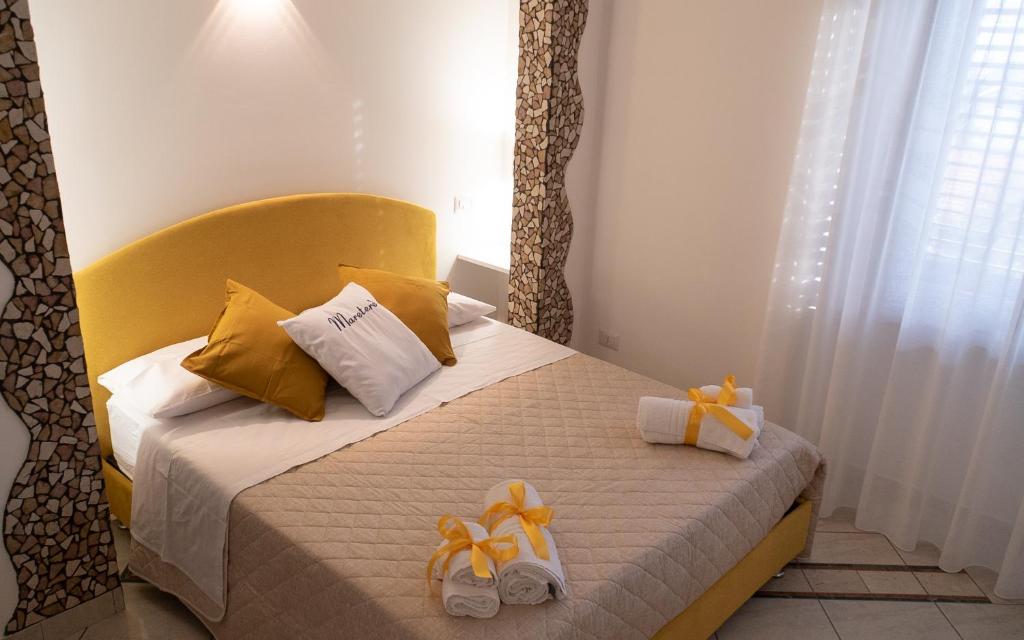 a bedroom with a bed with two slippers on it at Mareterè in Vietri sul Mare