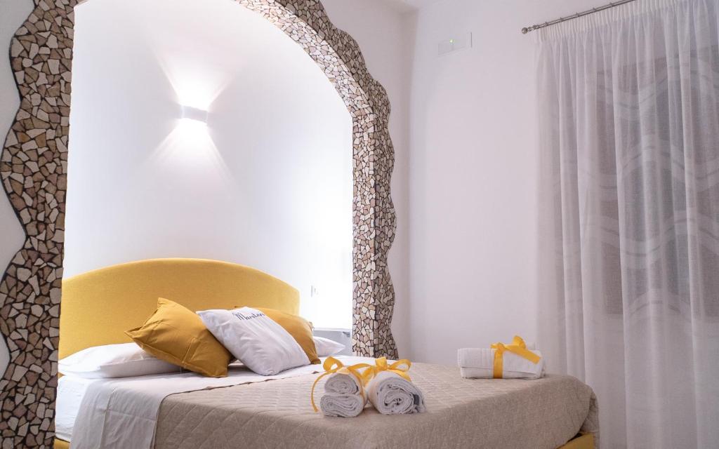 a bedroom with a bed with two towels on it at Mareterè in Vietri sul Mare