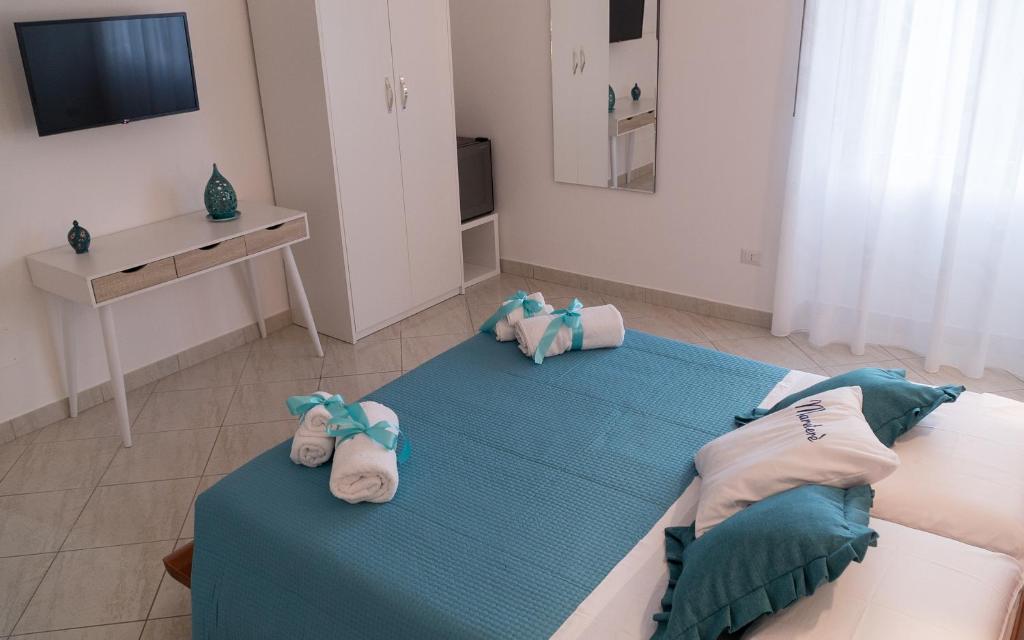 a bedroom with two beds with stuffed animals on them at Mareterè in Vietri sul Mare