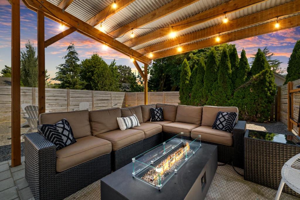 a patio with a couch and a fire pit at Beautiful, Historic Home, heart of McMinnville. in McMinnville