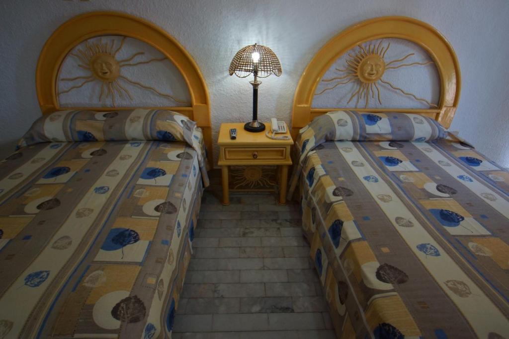 Postel nebo postele na pokoji v ubytování Imperial Las Perlas