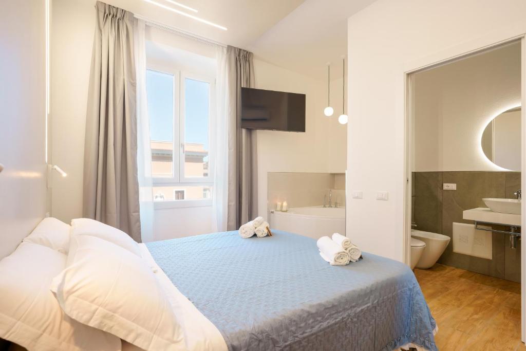 a bedroom with a bed and a tub and a sink at Aqua Comfort Rooms - Eja Sardinia in Cagliari