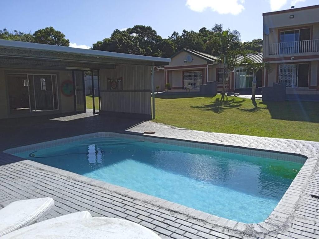 a swimming pool in the yard of a house at Heberden chalets in Melville