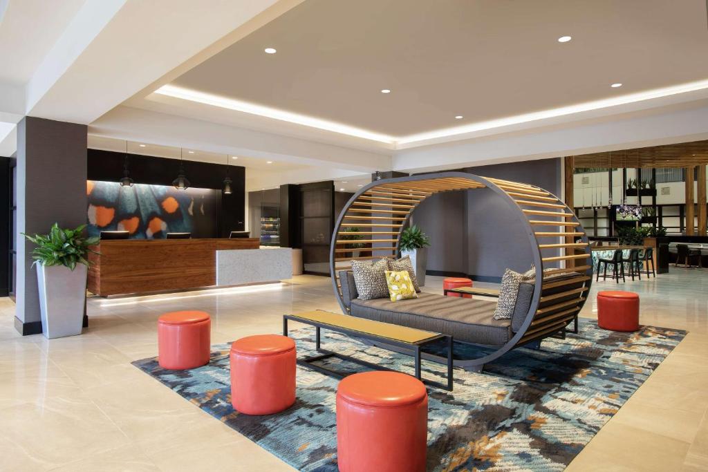 a living room with a couch and a chair at Embassy Suites Orlando - Airport in Orlando