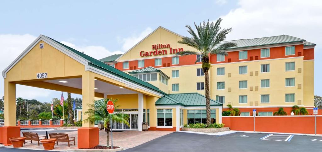 a hotel with a stop sign in a parking lot at Hilton Garden Inn Tampa Northwest/Oldsmar in Oldsmar