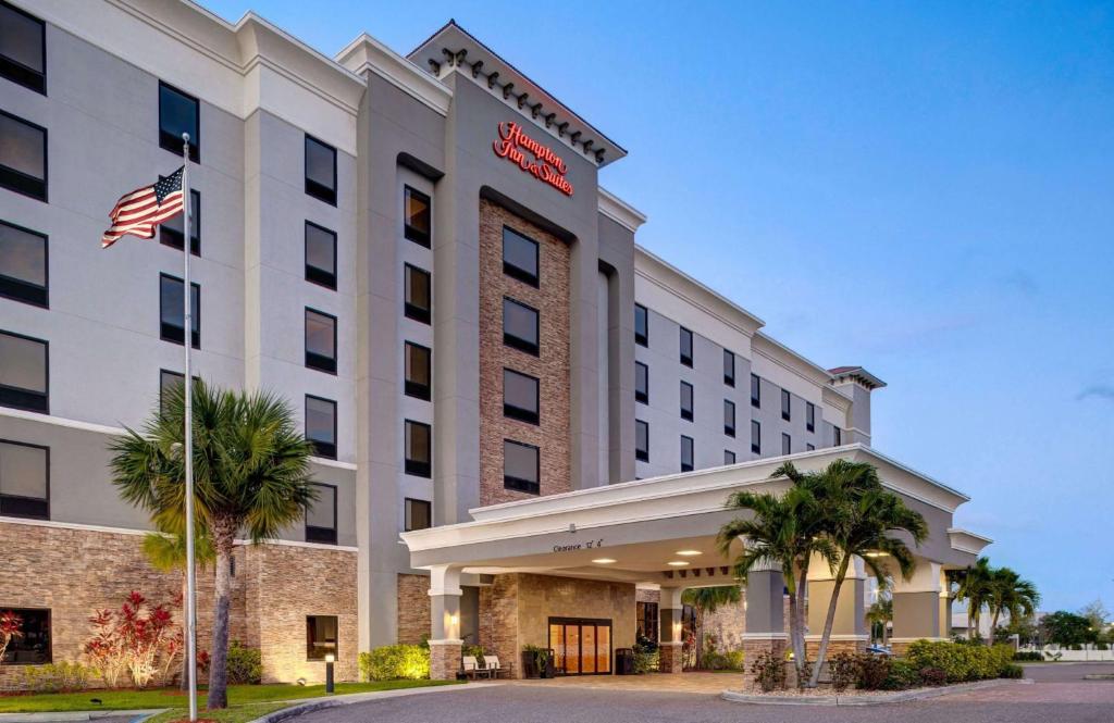 a hotel with an american flag in front of it at Hampton Inn & Suites Tampa Northwest/Oldsmar in Oldsmar