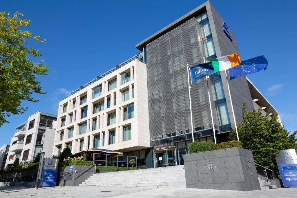 a building with a flag in front of it at Hilton Dublin Kilmainham in Dublin