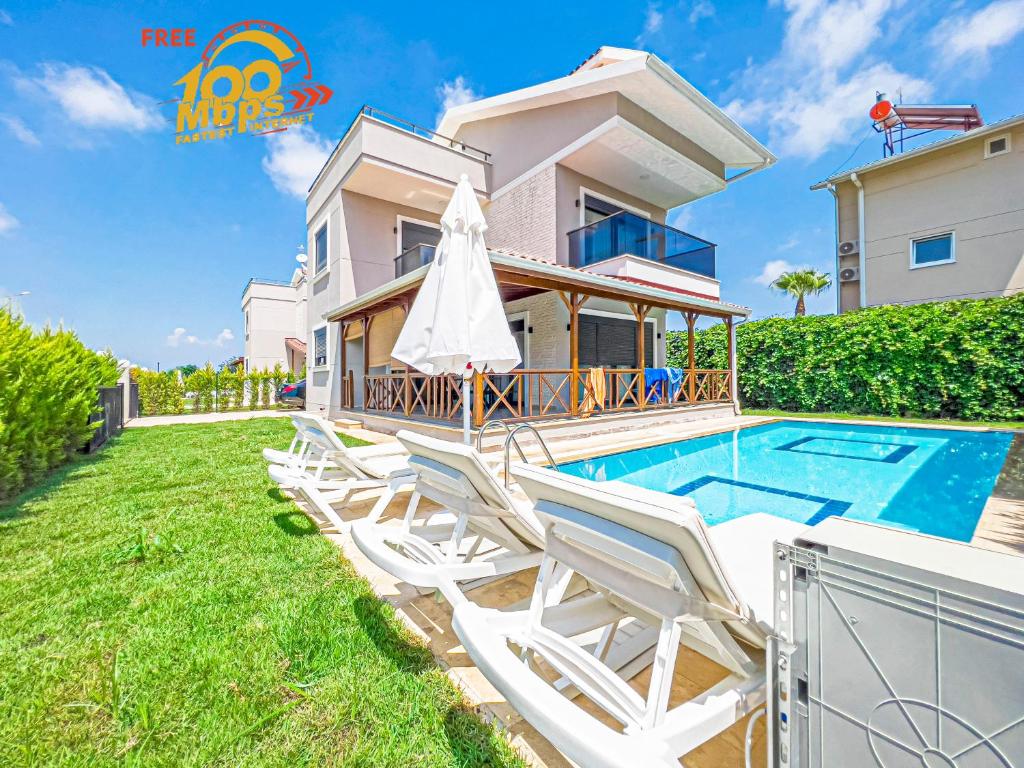 a villa with a swimming pool and lounge chairs at Paradise Town Villa Cordelia 100 MBPS free wifi in Belek
