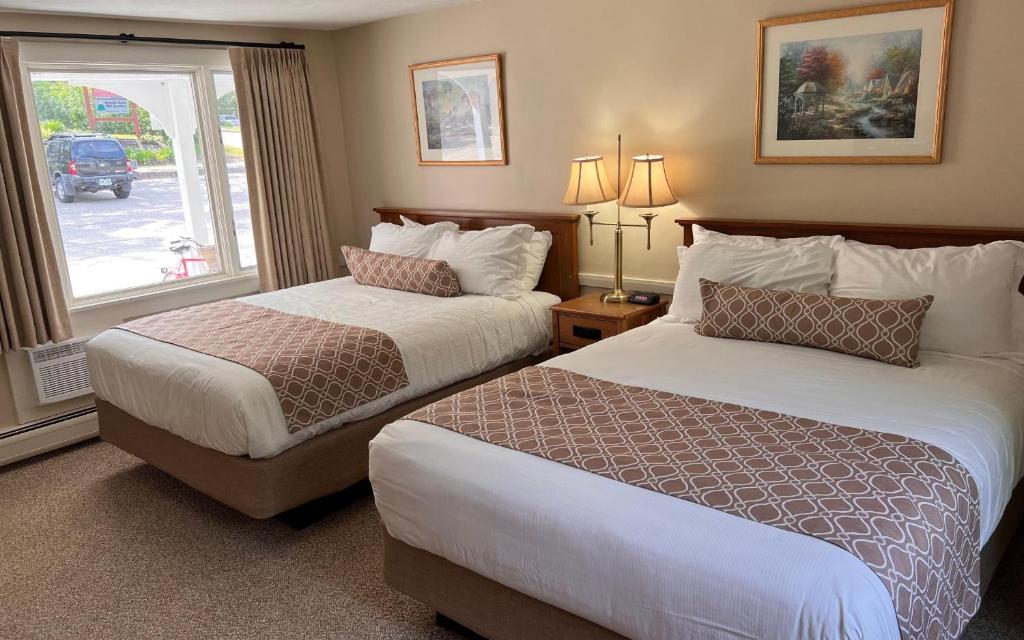a hotel room with two beds and a window at Village Place in Conway
