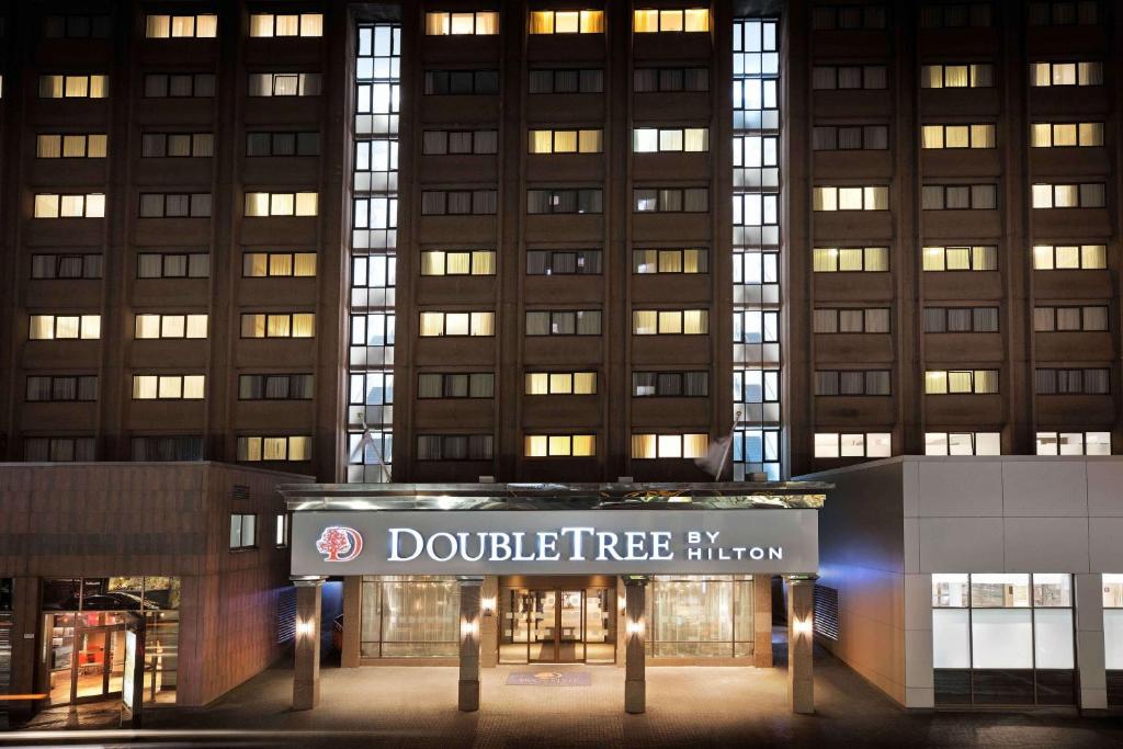un edificio con un cartel de corona de árbol doble delante en DoubleTree by Hilton Glasgow Central en Glasgow