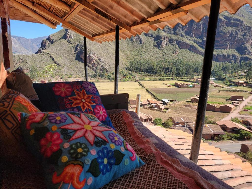 a porch with a couch and a view of a mountain at Wolf Totem Steam Punk Loft Villa in Pisac