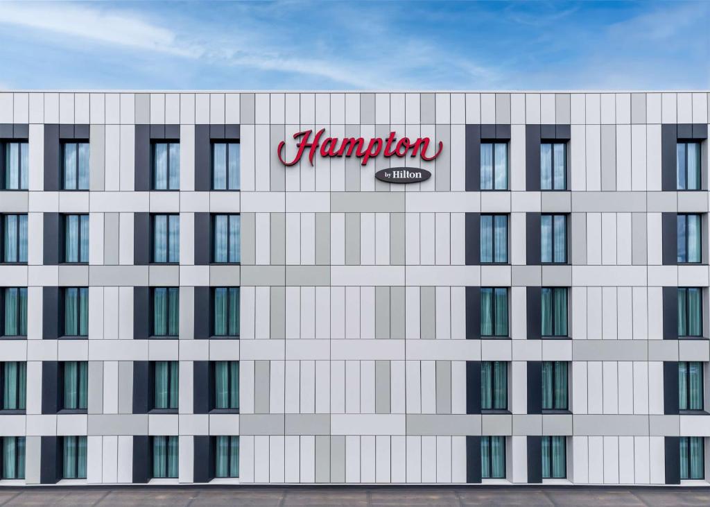 a building with a sign on the side of it at Hampton by Hilton High Wycombe in High Wycombe