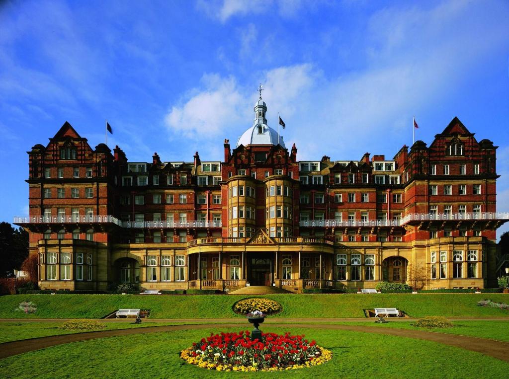 a large building with a fountain in front of it at DoubleTree by Hilton Harrogate Majestic Hotel & Spa in Harrogate