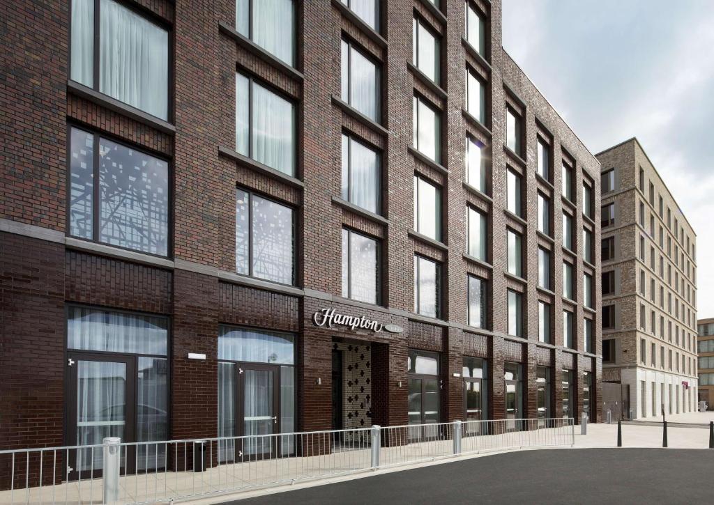 a rendering of the front of a brick building at Hampton By Hilton London Docklands in London