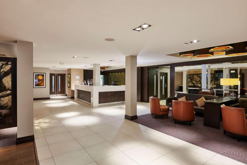 a lobby of a hotel with couches and chairs at DoubleTree by Hilton London Ealing in London