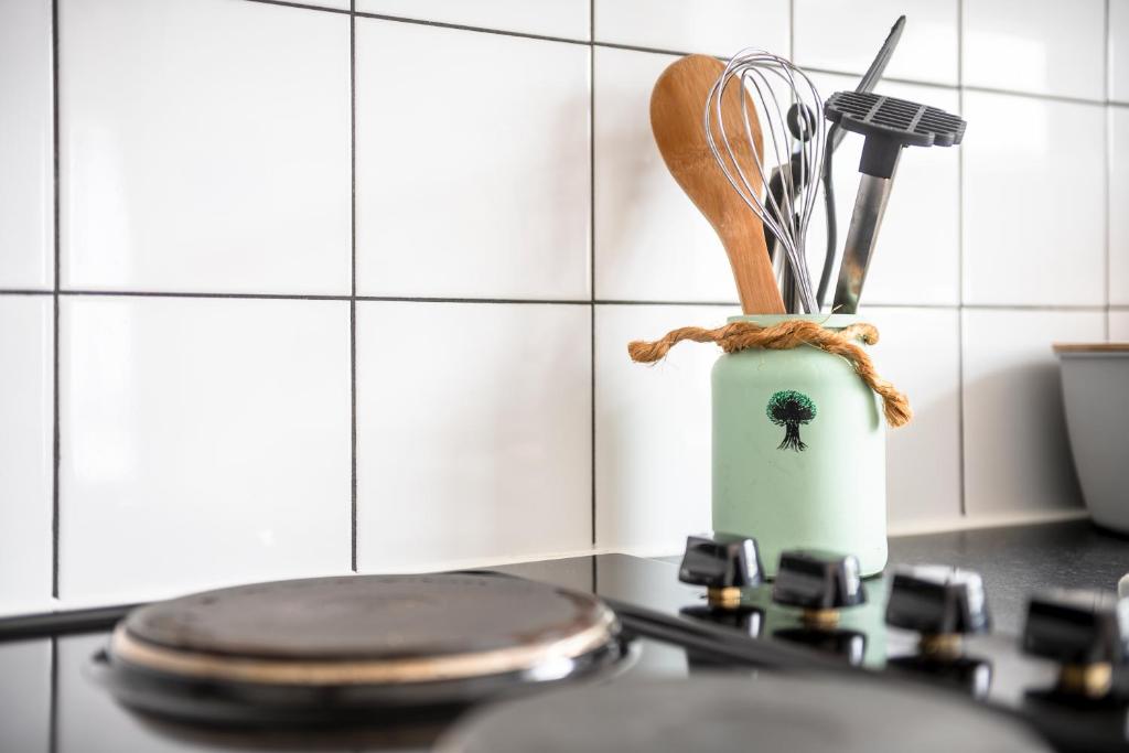 a kitchen counter with a stove with a knife and a whisk at Lytton Tree Lodge- 7 Self-Contained Lodges in Reydon