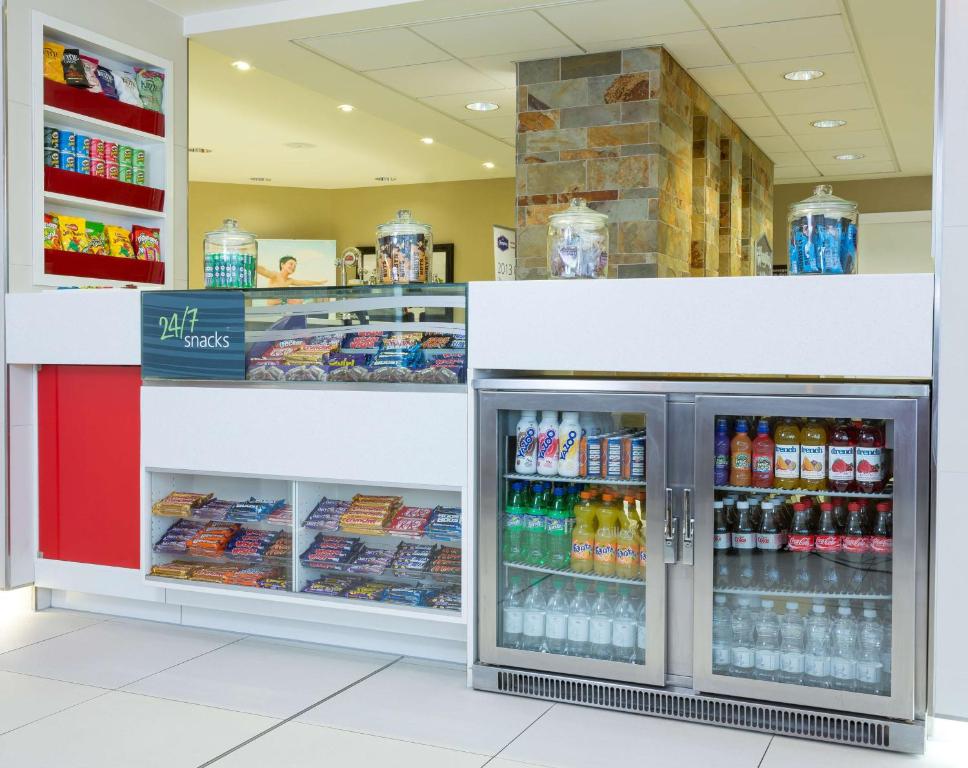 a grocery store store with a refrigerator filled with drinks at Hampton by Hilton Liverpool John Lennon Airport in Speke