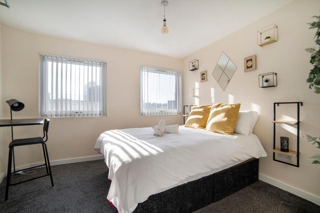 a bedroom with a bed and two windows at Leicester City Center The Boat House Building in Leicester