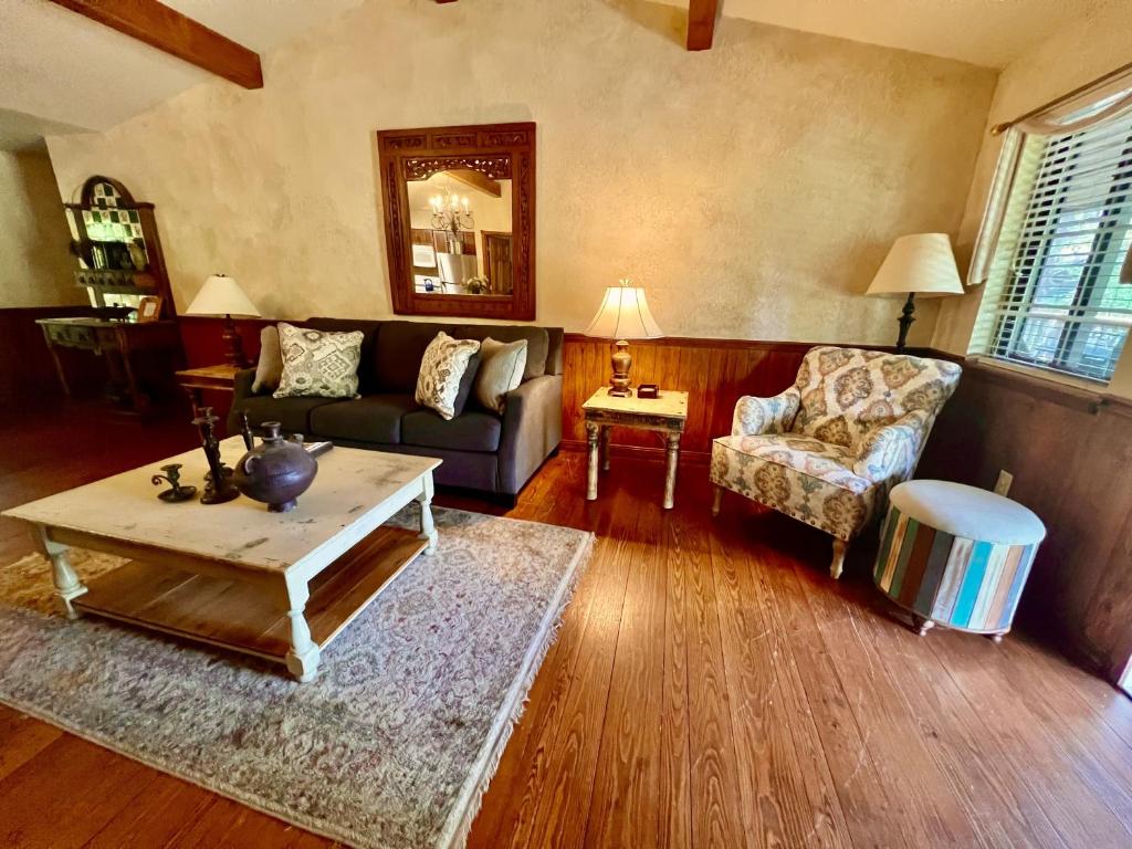 a living room with a couch and a coffee table at C7, Three bedroom, three bath log-sided, luxury Harbor North cottage with hot tub cottage in Mount Ida