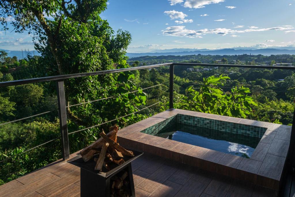 a jacuzzi tub on a deck with a view at El Edén Country hotel y Club Residencial in Armenia