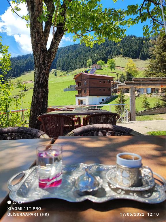 a table with a cup of coffee on top of it at Gumul pansiyon in Uzungöl