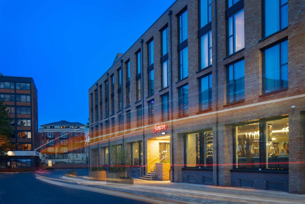 a large brick building on a city street at Hampton by Hilton York Piccadilly in York