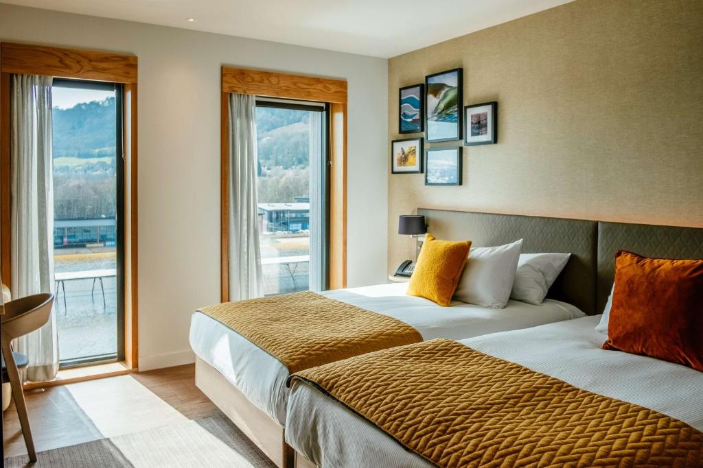 a hotel room with two beds and a window at Hilton Garden Inn Snowdonia in Conwy