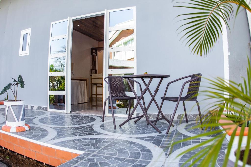 a patio with two chairs and a table on a patio at Cambria Hotel in Nosy Be