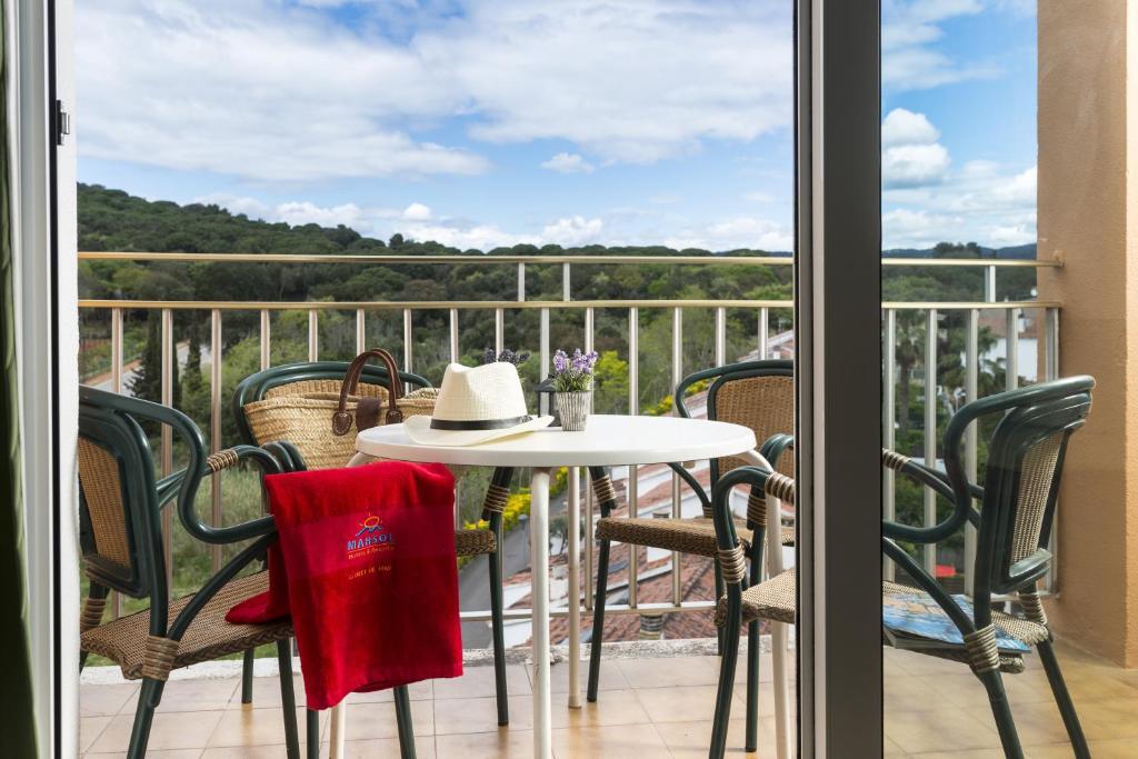 a table and chairs on a balcony with a view at Apartaments Condado by Marsol in Lloret de Mar