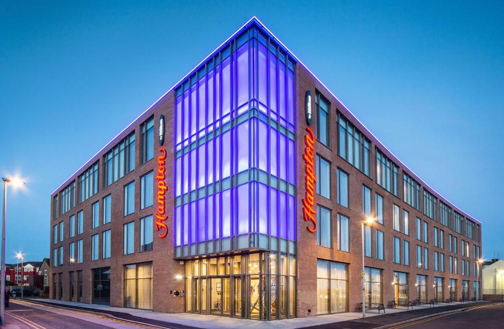 a large building with lights on the side of it at Hampton By Hilton Blackpool in Blackpool